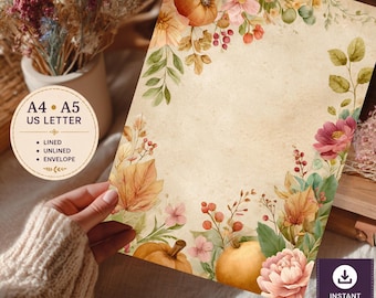 May include: A stationery sheet with a vintage-style beige background featuring a watercolor border of orange pumpkins, pink flowers, red berries, and green foliage. Text on the image includes A4, A5, US LETTER, LINED, UNLINED, ENVELOPE, and INSTANT DOWNLOAD.