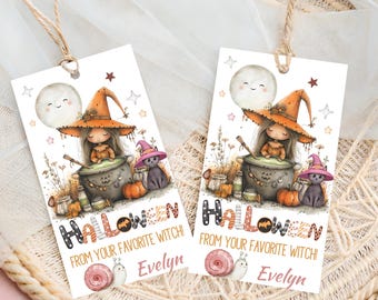 May include: Two Halloween-themed gift tags with a witch illustration. Each tag features a witch in an orange hat, a cauldron, a black cat, and the text "Halloween from your favorite witch!" with the name "Evelyn". The tags are decorated with pumpkins, stars, and a smiling moon.