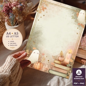 May include: A rectangular stationery sheet featuring a watercolor illustration of two white ghosts, orange pumpkins, a stack of books, and a lit candle. The border is gold with autumn leaves. Text includes A4, A5, US LETTER, LINED, UNLINED, ENVELOPE.