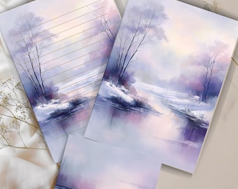 May include: Stationery set featuring a winter landscape painting in shades of purple, blue, and white. The set includes lined paper, a blank card, and a larger card with the same artwork. The artwork depicts a snowy scene with trees and a river.