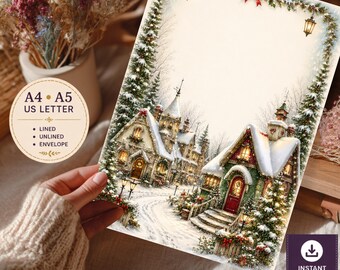 Printbare briefpapierset met kerstdorpmotief – Briefpapier met een besneeuwd kersthuisje en een feestelijke rand.