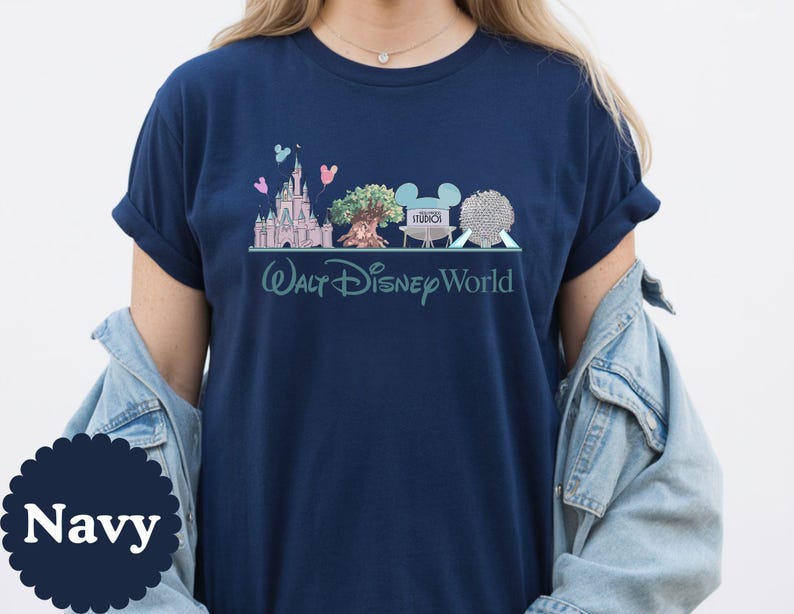 May include: Navy blue t-shirt with a graphic of Walt Disney World landmarks, including Cinderella's Castle, the Tree of Life, and Spaceship Earth. The words "Walt Disney World" are printed below the graphic in a script font.