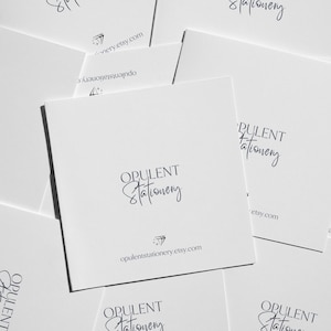 multiple white business cards or envelopes with the text "OPULENT Stationery" printed on them.
