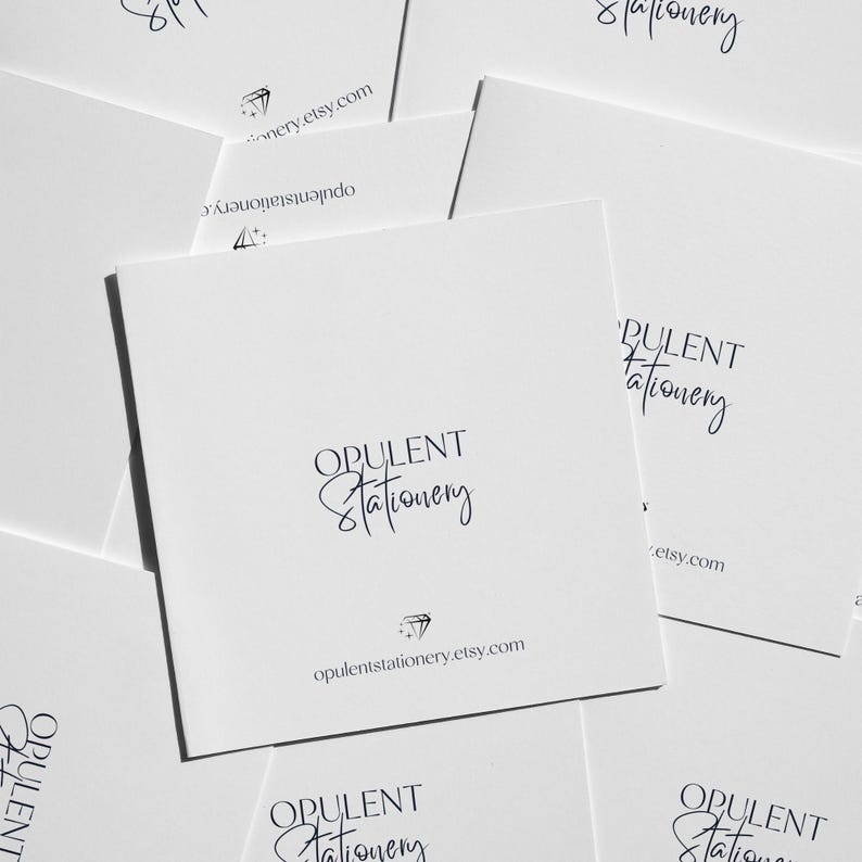 multiple white business cards or envelopes with the text "OPULENT Stationery" printed on them.