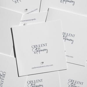 multiple white business cards or envelopes with the text "OPULENT Stationery" printed on them.