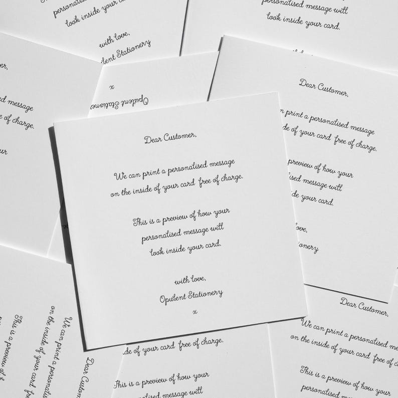 multiple handwritten letters on white cards, with each letter written in a different cursive style. The letters appear to be personalized messages addressed to customers, offering a free card with a personalized message. The cards are spread out, creating a collage-like effect. The text on the cards is written in various fonts and sizes, creating a visually interesting and diverse collection of handwritten messages.