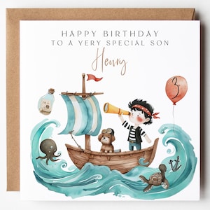 May include: A birthday card with a brown kraft paper border. The card features a watercolour illustration of a pirate ship with a boy, dog, and sea creatures. Text reads "HAPPY BIRTHDAY TO A VERY SPECIAL SON Henry" and a balloon with the number 3.