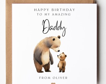 May include: A square white greeting card featuring a watercolor illustration of a large brown bear looking down at a small brown bear cub. The text reads "HAPPY BIRTHDAY TO MY AMAZING Daddy" and "FROM OLIVER" with a small brown heart icon below.