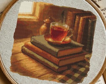 May include: A cross-stitch embroidery hoop featuring a still life with a cup of tea on a stack of books. The artwork is framed by a wooden hoop and set against the backdrop of an open book. The color palette is warm, with shades of brown and orange.