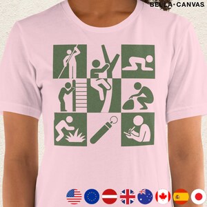 以下が含まれることがあります： 薄いピンク色のBella+Canvas Tシャツ。緑色のグラフィックは9つの正方形で構成され、それぞれが屋外活動を行う人物を描いています。Tシャツはクルーネックと半袖です。柔らかく快適な素材で作られています。