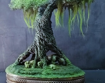 May include: A miniature mossy green tree with a thick, gnarled trunk and long, trailing vines. The tree is displayed on a round, ornate metal base.
