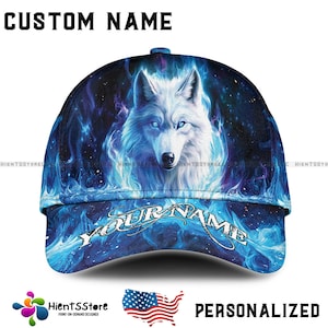 May include: A personalized baseball cap featuring a white wolf with blue eyes and a blue flame design. The text "CUSTOM NAME" is at the top, and "YOUR NAME" is on the brim. The cap is a personalized item.