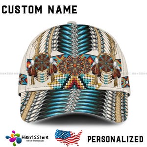 May include: A white baseball cap featuring a blue, white and red Native American design. The cap has a custom name on the front.