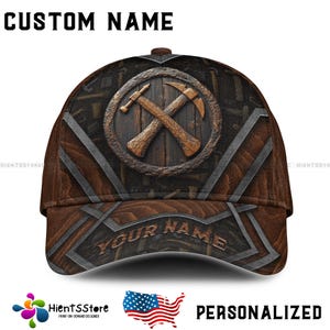 May include: A brown baseball cap with a personalized name and a wood-toned design featuring crossed hammers. The cap has a brown and white pattern with a wood-grain texture.
