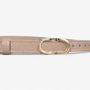 May include: A light brown leather belt with a gold-toned double-C buckle.