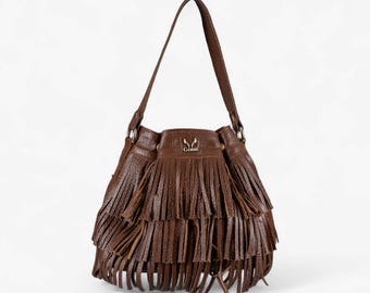 May include: A brown leather shoulder bag with a long strap and a layered fringe design. The bag has a rounded shape and a small logo on the front. The bag is made of a textured leather material.