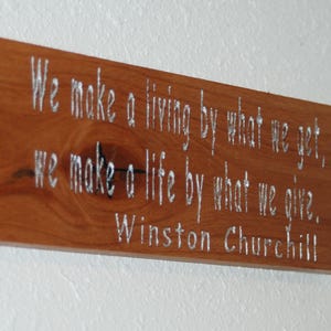 We make a living by what we get, we make a life by what we give. Winston Churchill - Hand painted carved plaque.   25004