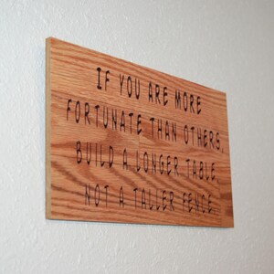 May include: A handmade wooden sign displaying the word "Welcome" in a whimsical font. The sign has a distressed white backdrop and a dark brown frame, suitable for a front door or hallway.