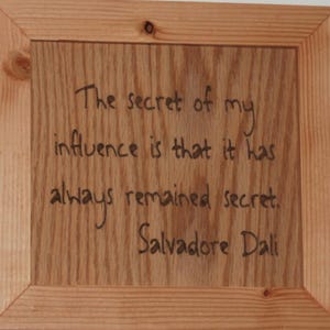 The secret of my influence is that it has always remained secret. Salvadore Dali - Carved wooden plaque - 14027