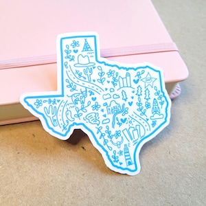 May include: A blue outline of the state of Texas with various illustrations inside, including a cowboy hat, cactus, stars, and a lighthouse. The outline is on a white background.