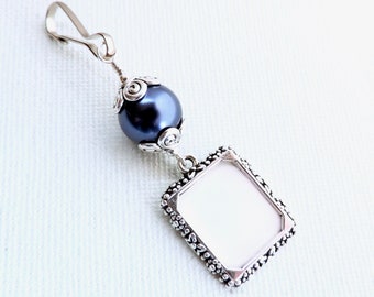 Wedding bouquet charm with a small picture frame and a navy blue pearl. Something blue for the bride to be.