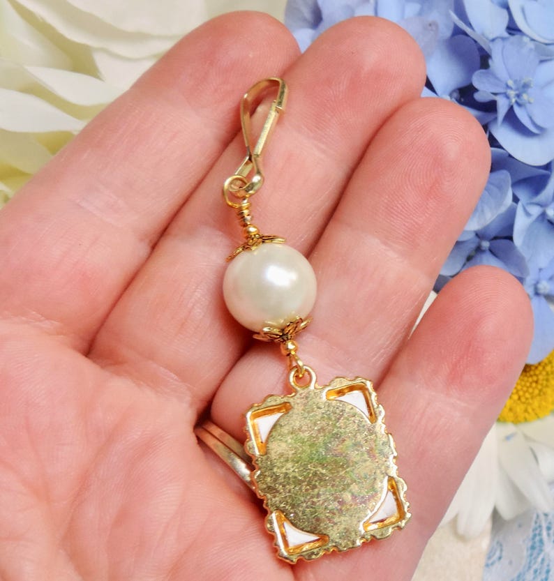 A lovely wedding bouquet photo charm in golden tones featuring an ivory, white, blue or pink shell pearl bead and small picture frame. 
What a thoughtful bridal shower gift. Just add your picture of a loved one, or let me do the photo too :)