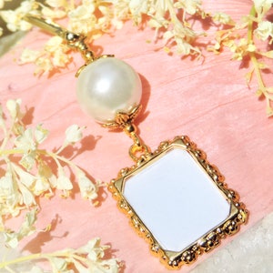 A lovely wedding bouquet photo charm in golden tones featuring an ivory, white, blue or pink shell pearl bead and small picture frame. 
What a thoughtful bridal shower gift. Just add your picture of a loved one, or let me do the photo too :)