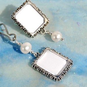 A lapel pin and a wedding bouquet charm set for the bride and groom. Both have a small picture frame in antique silver tones and a freshwater pearl. You can add the photos yourself or chose for me to do them. Other beads & colors available- just ask.