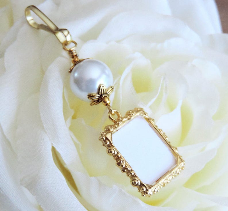 A lovely wedding bouquet photo charm in golden tones featuring an ivory, white, blue or pink shell pearl bead and small picture frame. 
What a thoughtful bridal shower gift. Just add your picture of a loved one, or let me do the photo too :)