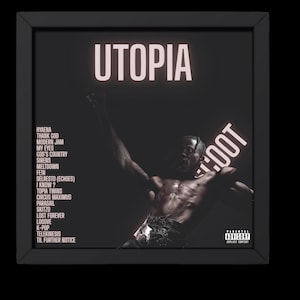 May include: A framed album cover with the title "UTOPIA" in illuminated white letters. The cover features a dark image of a person with arms raised, and the album's tracklist is listed on the left side. The words "BOOT" and "PARENTAL ADVISORY EXPLICIT CONTENT" are also visible.