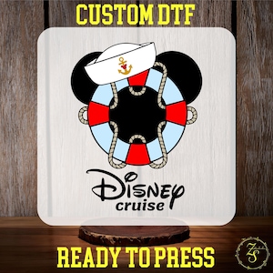 May include: A white square with a nautical-themed design featuring Mickey Mouse ears, a sailor hat, and a life preserver in red, white, and blue. The words "Disney cruise" are below the design. The text "CUSTOM DTF" and "READY TO PRESS" are at the top and bottom.