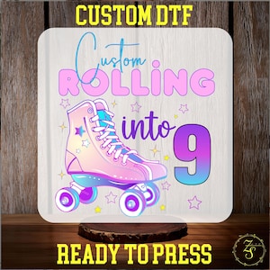 May include: A square, white sublimation blank with a roller skate design. The design features a pink and blue roller skate with the text "Custom Rolling into 9". The words "Custom DTF" and "Ready to Press" are also present.