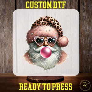 May include: A pink and brown Santa Claus with a leopard print hat, heart-shaped sunglasses, and a pink bubble. The Santa Claus is wearing a white beard and has a pink and white fur trim on his hat. The image is on a white background.