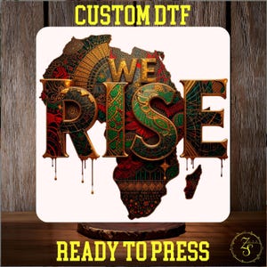 May include: A square design with the African continent in red, green, and gold patterns, and the words "WE RISE" in large, ornate letters. The text "CUSTOM DTF" and "READY TO PRESS" are displayed in yellow.