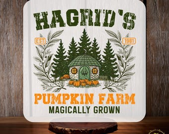 May include: A white square sign with the text "Hagrid's Pumpkin Farm" in orange and green. The design includes a green cottage, pumpkins, and evergreen trees. The words "Custom DTF" and "Ready to Press" are also displayed.