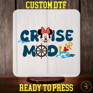 May include: A white iron-on transfer design featuring a cartoon mouse wearing a red bow, a ship's wheel, an anchor, and the text "Cruise Mode".