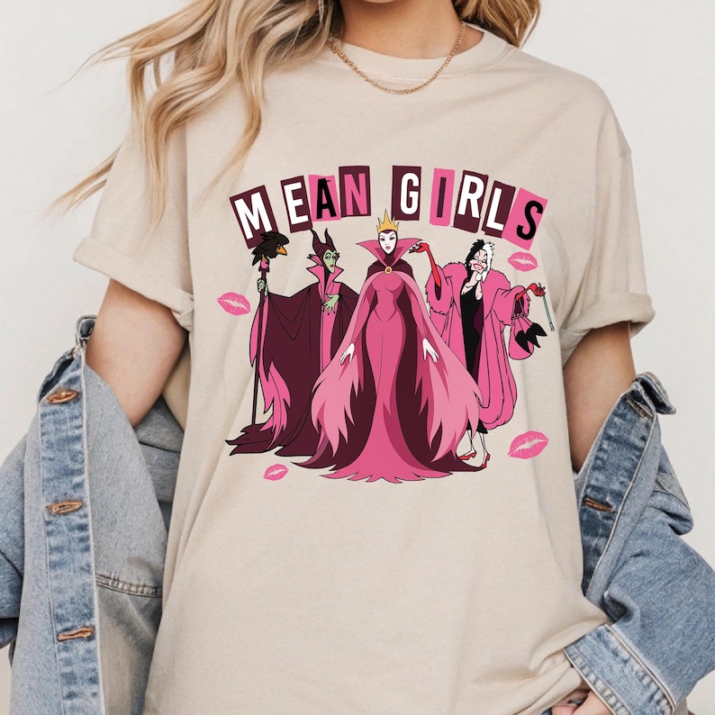 Hero mockup of Mean Girls villains DTF transfer featuring Maleficent, Cruella, and Evil Queen in pink retro style, funny Halloween ready to press design.

Close-up of Disney villains Mean Girls DTF print with pink dresses, kiss marks, and retro lettering, humorous Halloween apparel design.