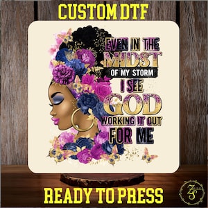 May include: A square sublimation design featuring a Black woman with a floral headpiece and gold hoop earrings. The design includes the text "EVEN IN THE MIDST OF MY STORM I SEE GOD WORKING IT OUT FOR ME" and "READY TO PRESS".