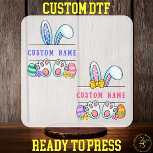 May include: Two white designs with bunny ears, paw prints, and Easter eggs. The text "CUSTOM NAME" is included in both designs. The designs are ready to press.