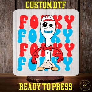 May include: A white background with a red and blue repeating pattern of the word "Forky". A cartoon character of Forky from the Toy Story movie is in the center of the design. Forky is a white plastic spork with googly eyes, red arms, and a white shirt. The text "Custom DTF" is at the top of the design and "Ready to Press" is at the bottom.