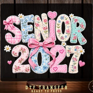 May include: A DTF transfer design featuring the text SENIOR 2027 in a quilted fabric style. The letters and numbers are decorated with pink gingham, floral patterns, polka dots, and small daisies. A large pink ribbon bow sits in the center.