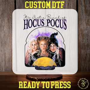 May include: A white sublimation blank with the text "It's Just a Bunch of Hocus Pocus" and an image of the three Sanderson sisters from the film Hocus Pocus. The image is in a purple and yellow watercolour style.