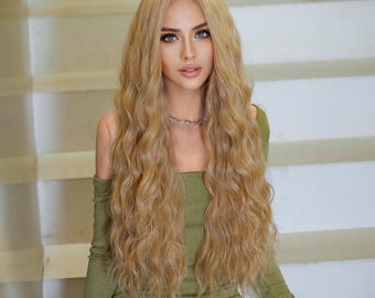 May include: A woman with long, wavy, light blonde hair wearing a green off-the-shoulder dress.