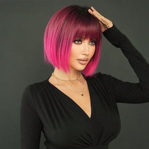 May include: A short, straight bob wig with a fringe. The wig is a dark pink color at the roots and fades to a bright pink at the ends.