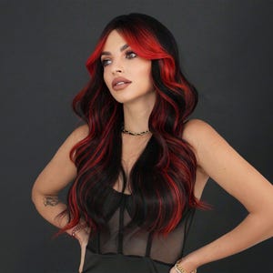 May include: A woman with long, wavy black hair with streaks of red. The hair is styled with a side parting and the red streaks are visible throughout the hair.