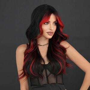 May include: A long, wavy black wig with red streaks throughout. The wig is styled with a side parting and falls to the shoulders.