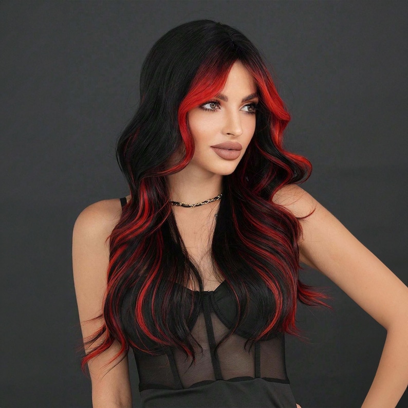 May include: A long, wavy black wig with red streaks throughout. The wig is styled with a side parting and falls to the shoulders.