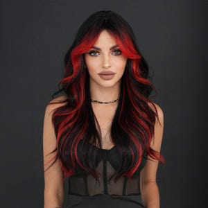 May include: A woman with long black hair with red streaks. Her hair is styled in loose waves. She is wearing a black top with a mesh design.