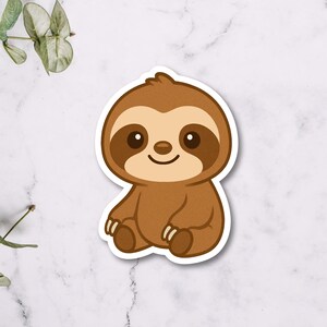 May include: A sticker featuring a cartoon sloth in shades of brown and tan. The sloth is sitting with its arms and legs slightly outstretched, and has a smiling expression. The sticker has a white border.