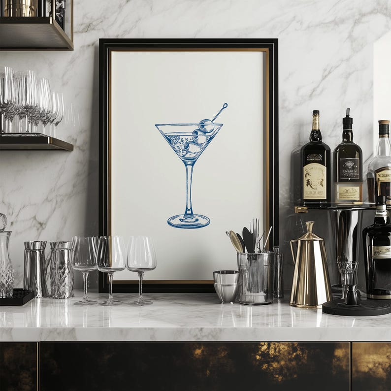 May include: A framed illustration of a martini glass with olives, in a blue and white color scheme, hanging on a wall above a bar counter with glassware and bottles.